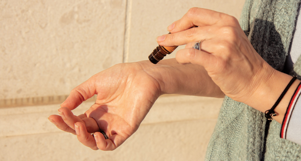 Editorial image of Doterra oils. Essential oils roller bottle in the hand of a woman